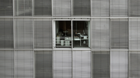 An office worker seen through a window.