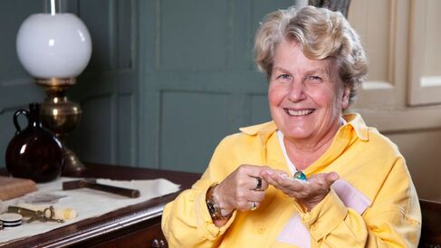 Sandi Toksvig holding a world map marble in Darwin’s room at Christs college Cambridge. photo credit Graham Copekoga