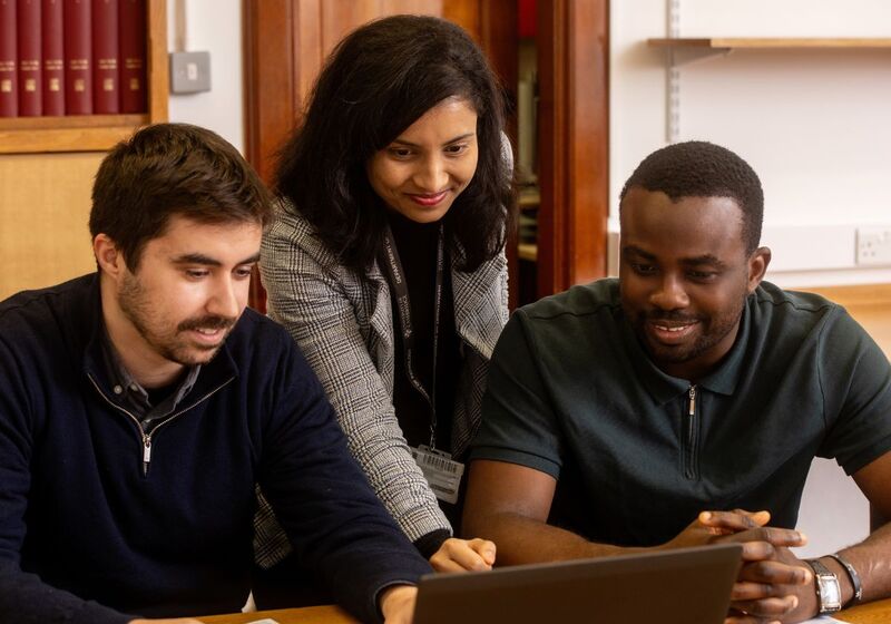 Three University students working in a meeting room. Copyright University of Cambridge (November 2024)