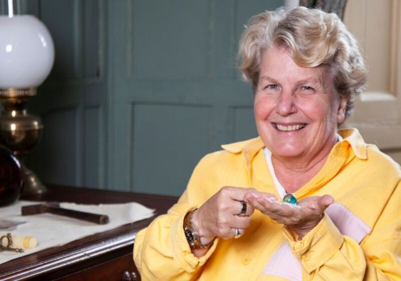 Sandi Toksvig holding a world map marble in Darwin’s room at Christs college Cambridge. photo credit Graham Copekoga