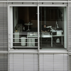 An office worker seen through a window.