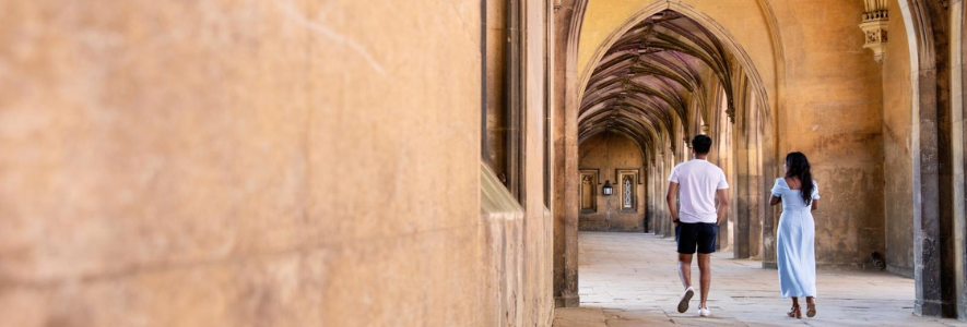 Students walking along a beautiful stone cloister in cambridge. Students walking along a beautiful stone cloister in cambridge.